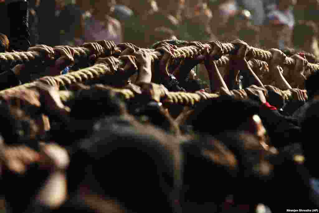 Nepalese devotees pull ropes tied to the chariot of Hindu god Bhairava during the Biska Jatra Festival in Bhaktapur, Nepal. (AP/Niranjan Shrestha)