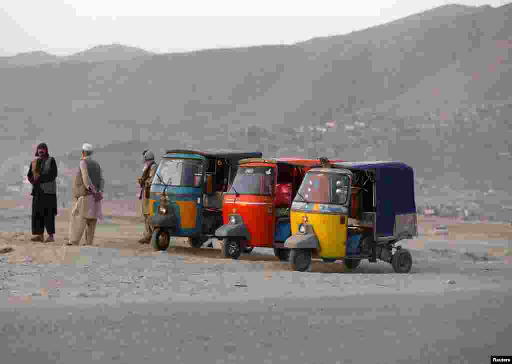 Afghan taxi drivers wait for passengers along a street in Kabul. (Reuters/Omar Sobhani)