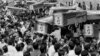 Mourners carry coffins through the streets of Tehran during a mass funeral for the victims of Iran Air Flight 655, which was shot down by the USS Vincennes in the Persian Gulf on July 7, 1988.