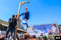 Demonstrators hang an effigy of Israeli Prime Minister Benjamin Netanyahu during the funeral for seven Islamic Revolutionary Guards Corps members killed in a strike in Syria, which Iran blamed on Israel, in Tehran on April 5.