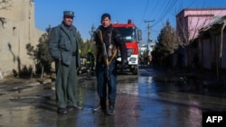There have been numerous attacks in the Afghan capital in recent months. Afghan security personnel stand guard at the site of a bomb attack on December 22.