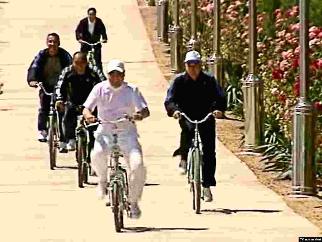 Even in leisure time, white is the color of choice for the Turkmen president, shown here bicycling with black-clad minders. Berdymukhammedov is frequently seen wearing white sweaters and fleece jackets during casual public appearances. 