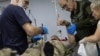 Ukrainian combat medics treat injured soldiers inside a medical stabilization point near the front line in the eastern Donetsk region on September 28.