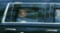US President Donald Trump looks out of the window of his limousine as he departs the White House for his Virginia golf club on May 30. 