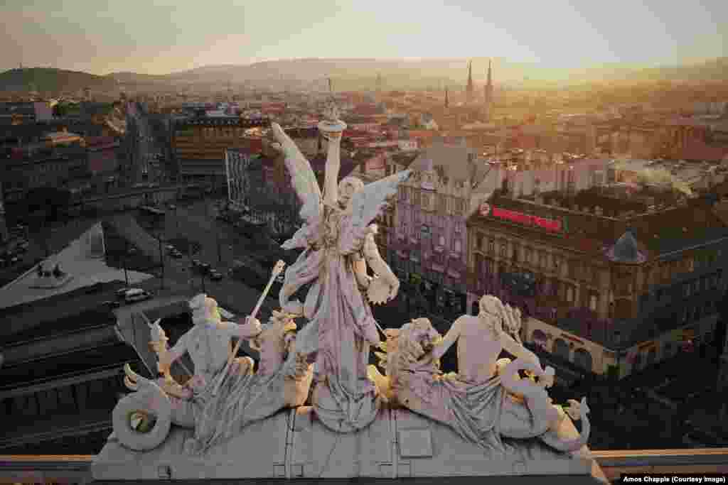 The three sculptures atop Keleti station, Budapest&#39;s main railway terminus, depict the gods of fire (left) and water (right) flanking a woman holding steam -- a combination of the two elements. Steam was the main power source for trains when the sculpture was made in 1884.