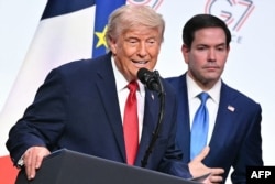 US President Donald Trump (left) talks to reporters alongside US Secretary of State Marco Rubio during a closing press conference at the G7 summit in Evian, France, on June 17.