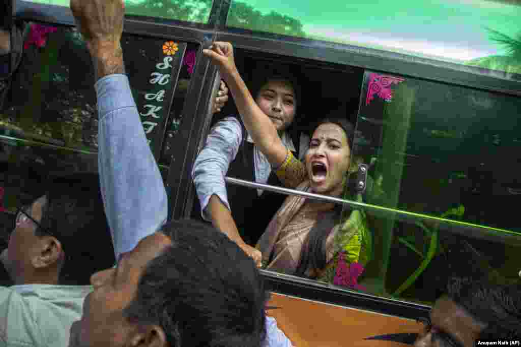 A woman shouts slogans from inside a bus after being detained during a protest in Gauhati on December 17.