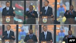  Barack Obama în decembrie 2013 la înmormîntarea lui Nelson Mandela la Johannesburg