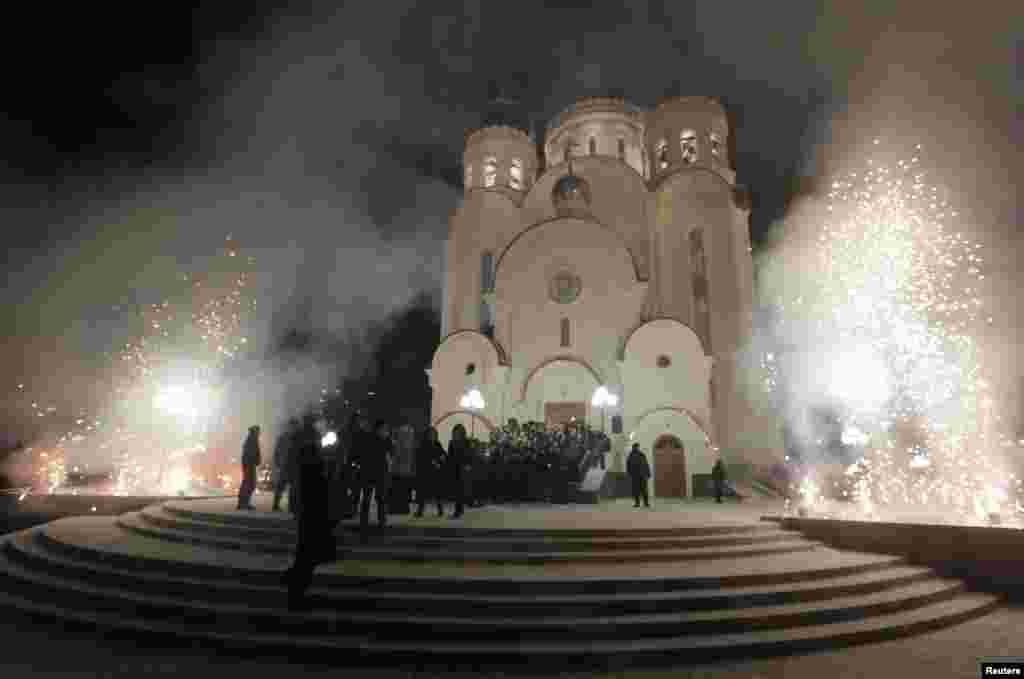 Clergy and believers watch fireworks during a Christmas service in the new Orthodox Church of the Nativity in Russia&#39;s Siberian city of Krasnoyarsk. Orthodox Christians celebrate Christmas according to the Julian calendar on January 7. (Reuters/Ilya Naymushin)