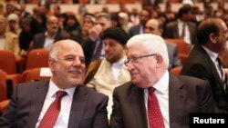 Iraq's new Prime Minister Haider al-Abadi (left) and Iraqi President Fuad Massum speak during the session to approve the new government in Baghdad on September 8.