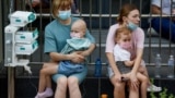 Women hold patients at Kyiv's Okhmatdyt children's hospital after a Russian missile strike on July 8. 