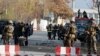 Afghan policemen inspect the site of a blast in Kabul on November 12.