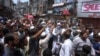 Shopkeepers stage a protest at a market demanding the government allow them to reopen their businesses in July. (file photo)