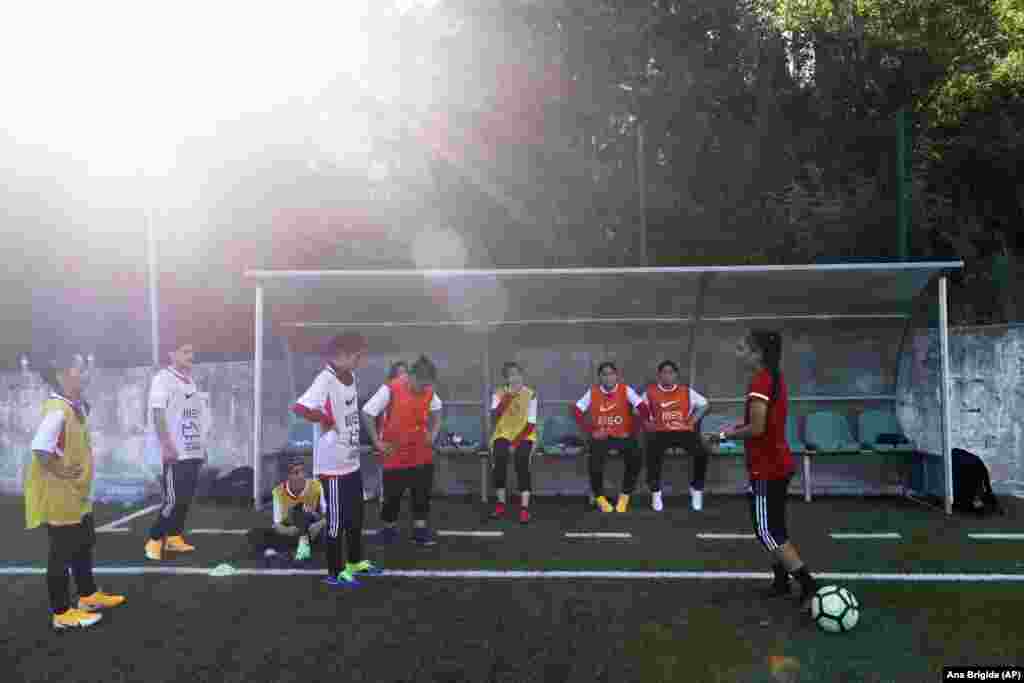 Farkhunda Muhtaj (right), the captain of the Afghan girls&#39; national soccer team, talks to her teammates during a training session at a pitch in Odivelas on the outskirts of Lisbon on September 30. &nbsp;