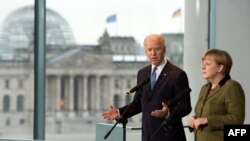 German Chancellor Angela Merkel and U.S. Vice President Joe Biden talk to journalists at the chancellery in Berlin.