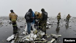 Russian Emergency Situations Ministry officers and investigators work at the crash site of the Boeing 737-800 Flight FZ981 operated by Dubai-based budget carrier FlyDubai at the airport of Rostov-On-Don on March 19.