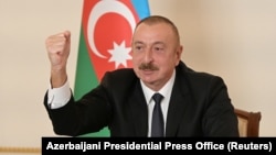 Azerbaijani President Ilham Aliyev gestures as he speaks during an address to the nation in Baku on October 26.