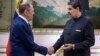 Venezuela's President Nicolas Maduro (right) shakes hands with Russian Foreign Minister Sergei Lavrov in Caracas on February 20.