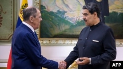 Nicolas Maduro shakes hands with Russian Foreign Minister Sergei Lavrov upon his arrival at the Miraflores Presidential Palace in Caracas, Venezuela, on February 20, 2024.