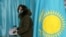 KAZAKHSTAN-ELECTION/ - A voter wearing protective mask votes during a parliamentary election in Almaty, Kazakhstan January 10, 2021.  REUTERS/Pavel Mikheyev