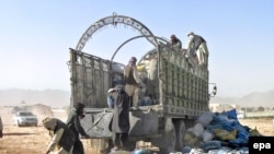 Workers unload drugs after they were seized in Kandahar in October 2008