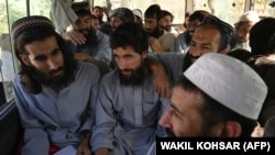 Taliban prisoners sit inside a vehicle during their release from the Bagram prison, next to the U.S. military base north of Kabul, on May 26.