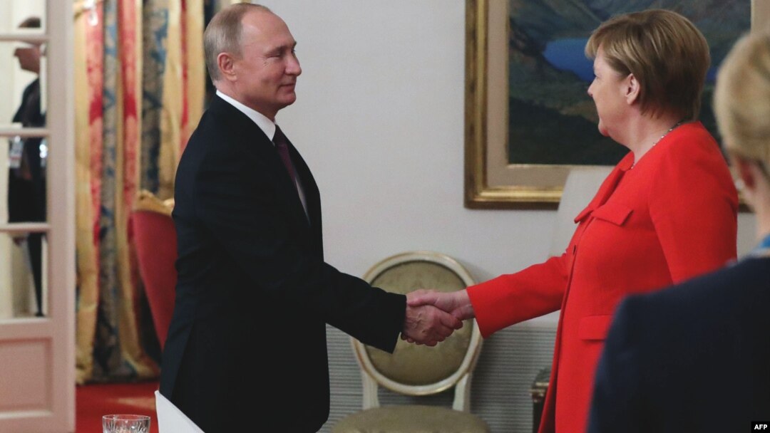 Russin President Vladimir Putin (left) and German Chancellor Angela Merkel shake hands during a bilateral meeting on the sidelines of the G20 in Buenos Aires. 