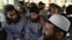 Taliban prisoners sit inside a vehicle during their release from the Bagram prison, next to the U.S. military base north of Kabul, on May 26.