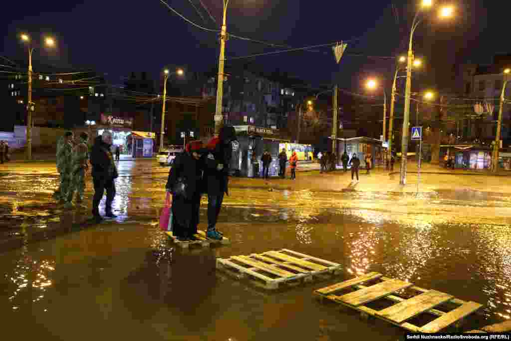 Жителі Києва переходять підтоплену вулицю