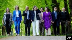 (From left) Victoria Nuland, U.S. undersecretary of state, U.K. Foreign Minister Elizabeth Truss, French Foreign Minister Jean-Yves Le Drian, Canadian Foreign Minister Melanie Joly, Japanese Foreign Minister Hayashi Yoshimasa, German Foreign Minister Annalena Baerbock, Italian Foreign Minister Luigi Di Maio, and EU foreign policy chief Josep Borrell take a walk at the G7 meeting in the German resort of Weissenhaus on May 12. 