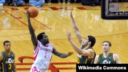 Enes Kanter (right) contests a shot by Houston Rockets player Patrick Beverly in an NBA game.