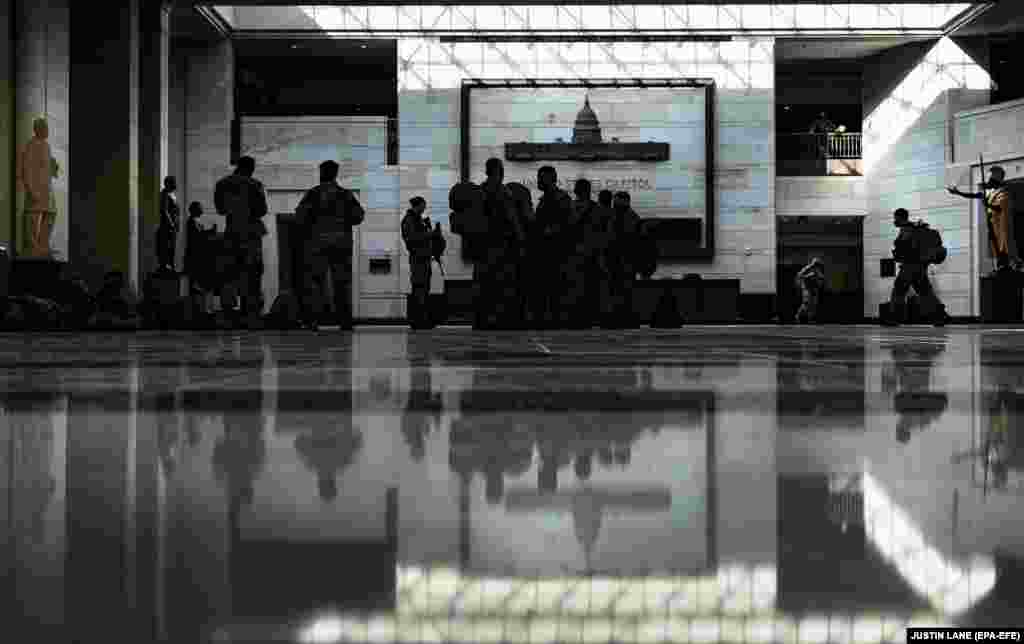 National Guard soldiers gather in the visitors center of the U.S. Capitol building in Washington, DC, January 14, 2021. EPA-EFE