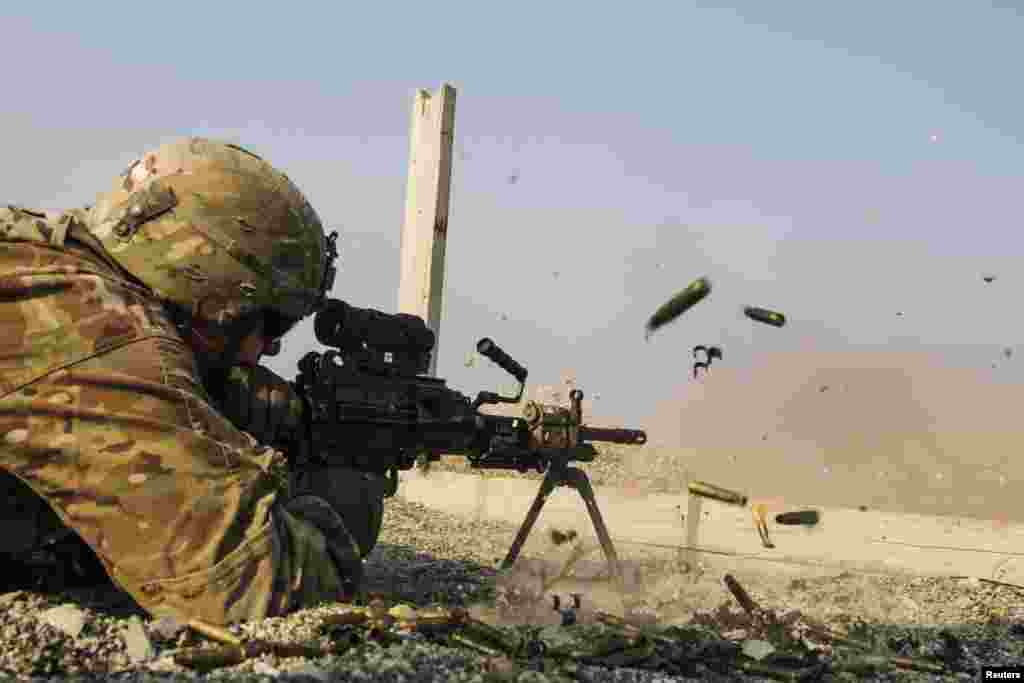 A U.S. soldier from the 3rd Cavalry Regiment is seen as he fires an automatic weapon during a training mission near Forward Operating Base Gamberi in Laghman Province. (Reuters/Lucas Jackson) 