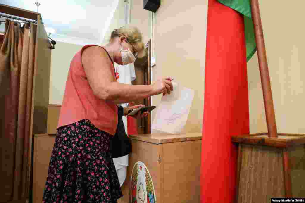 A woman casts her ballot at a polling station in Minsk.