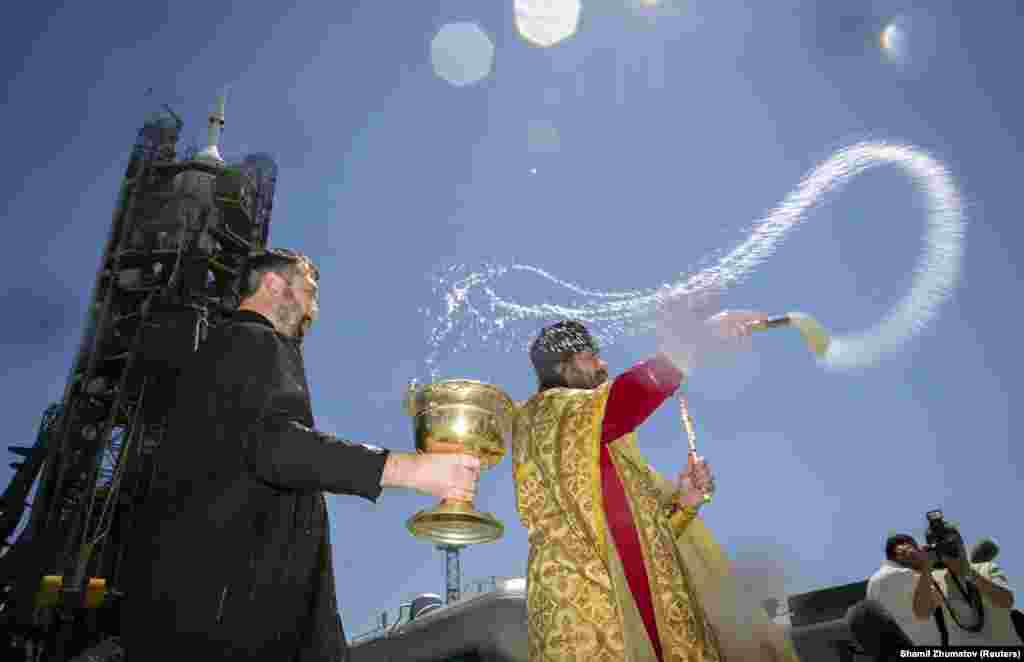 An Orthodox priest performs a blessing in front of a Soyuz spacecraft on the launch pad at the Baikonur Cosmodrome in Kazakhstan on May 27 before a mission to the International Space Station.