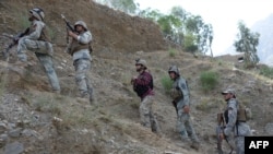 FILE: Afghan border policemen take their positions following clashes with Pakistani forces on the border between Afghanistan and Pakistan in the eastern Nangarhar Province in June 2016.