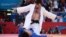 Russia's Mansur Isaev (white) celebrates after beating Japan's Riki Nakaya (blue) during their men's 73 kilogram judo contest final at the Olympic Games in London.