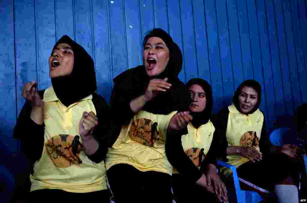 Female basketball players from Afghanistan's Herat Province cheer during a match against Kabul at the National Olympic Stadium in the Afghan capital. (AFP/Shah Marai)