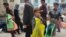 Afghan children sell plastic bags at a market in Kabul