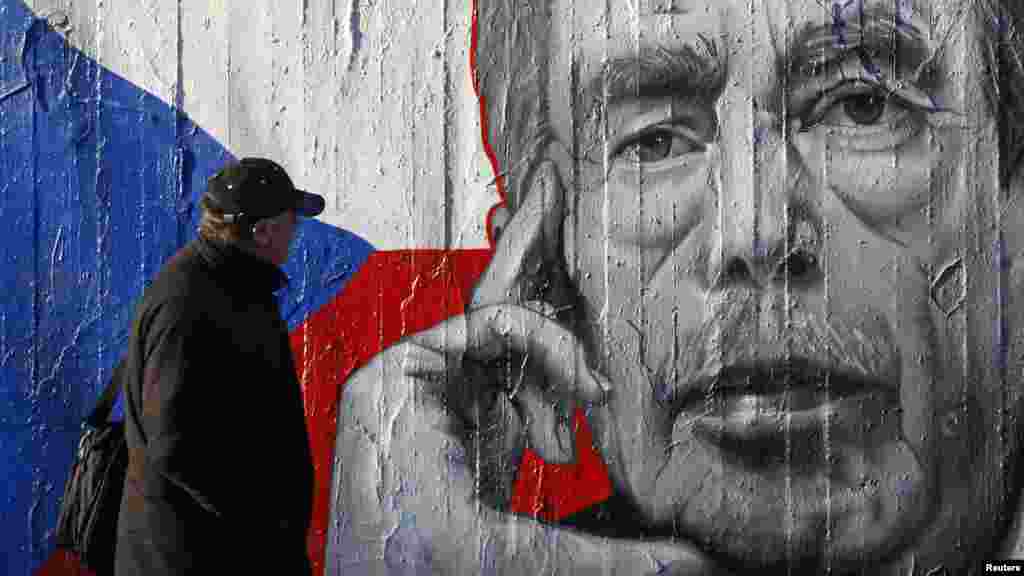 A man walks past graffiti depicting late former President Vaclav Havel in Prague. (Reuters/David Cerny)