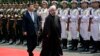 Iranian President Hassan Rohani (right) and Chinese President Xi Jinping review an honor guard during the welcome ceremony at the Xijiao State Guesthouse in Shanghai in May 2014.