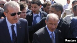 Libya -- Turkish Prime Minister Tayyip Erdogan (L) is greeted by Chairman of National Transitional Council Mustafa Abdel Jalil as he arrives in Tripoli, 16Sep2011