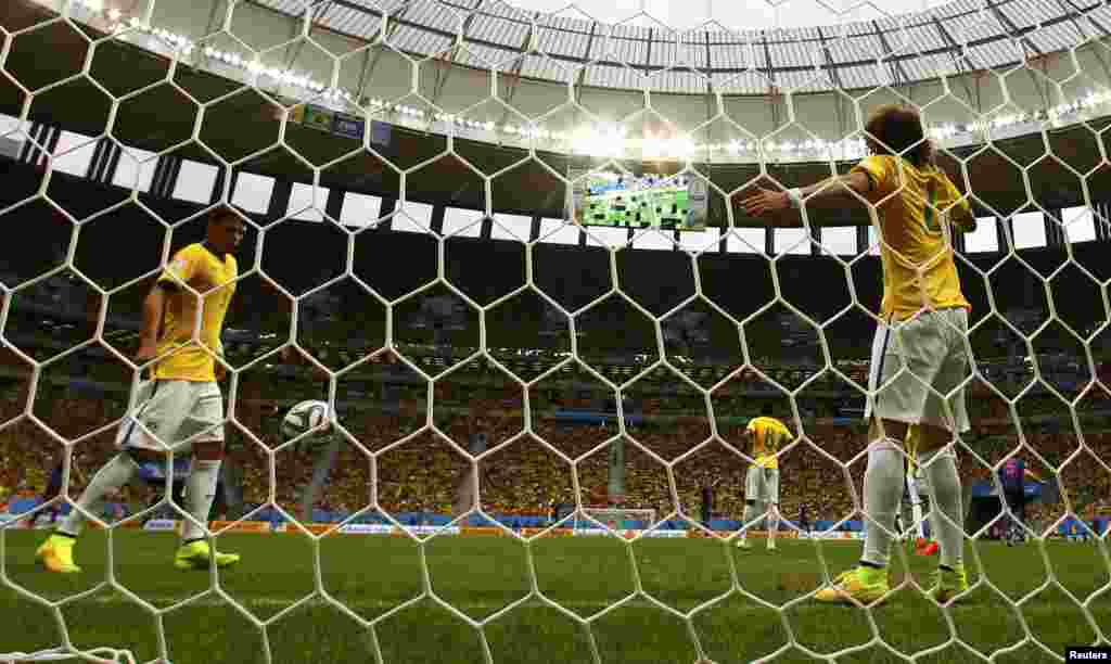 Brazil. 12Jul_Brazil's players Thiago Silva (3), Paulinho (8) and Marcelo (6) react after Daley Blind of the Netherlands (5) scored his team's second goal during their 2014 World Cup third-place playoff at the Brasilia national stadium in Brasilia