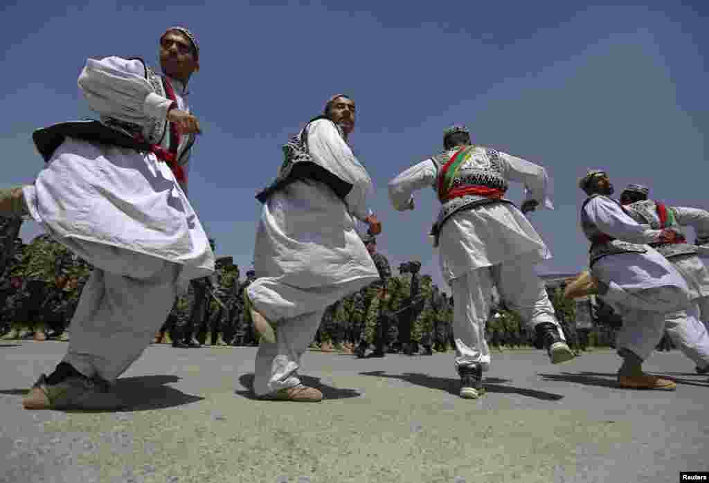 Afghan National Army soldiers, dressed in traditional clothing, dance during their graduation ceremony at the Kabul Military Training Center in Kabul. (Reuters/Omar Sobhani)