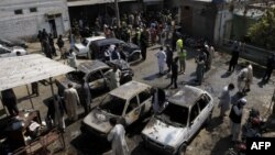 Pakistan -- Pakistani security officials inspect the site of a suicide bombing in Shabqadar, March 7, 2016