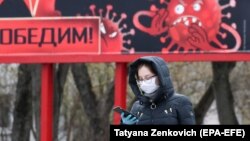 A billboard in Minsk illustrates the coronavirus, which has killed over 60 people in Belarus. 