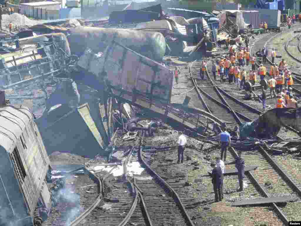 Emergencies Ministry staff work at the site of an explosion in the Belaya Kalitva station in the southern Russian region of Rostov-on-Don. The explosion on a freight train carrying chemicals and oil products hurled part of a railcar into a residential block, injuring 27 people. (Reuters)