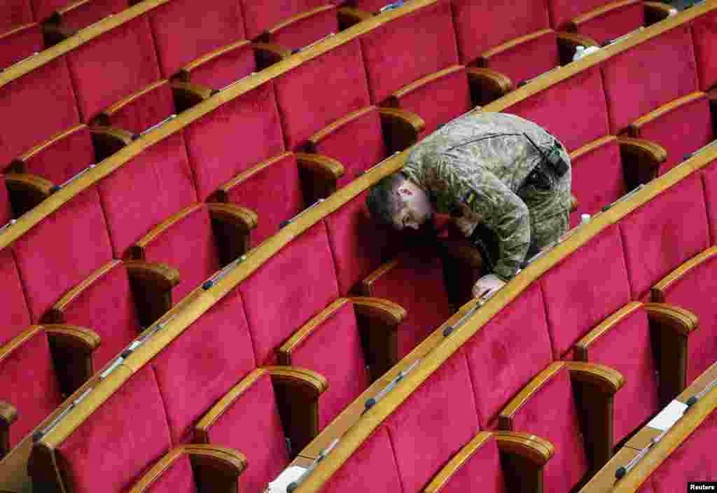 Ukrain howpsuzlyk gullugynyň harbysy sessiýadan ozal parlament binasyny barlaýar. Kiýew.(Reuters/Gleb Garanich)