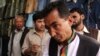 Ramazan Bashardost talks with Afghan men as he campaigns on the streets of Kabul in July.