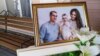 A photo of Igor, Milana, and Anastasia Kramarenko, who died in the collapse, is displayed before a farewell ceremony in Magnitogorsk on January 4.